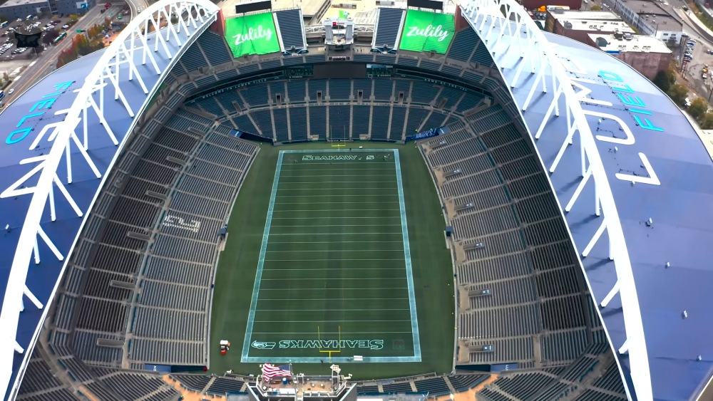 Aerial view of Lumen Field stadium showing Seahawks field and blue stands.
