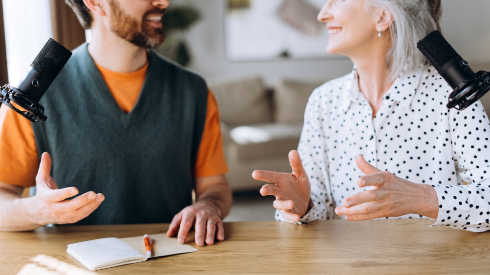 Man and Woman Discussing on Podcast with Microphones