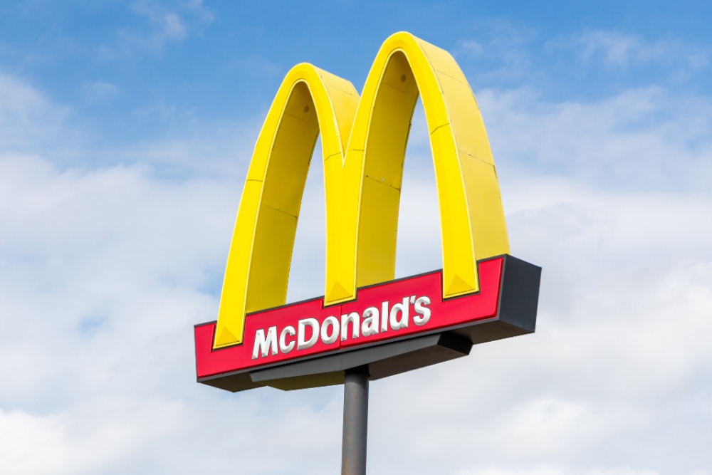McDonald's Golden Arches Sign Against Blue Sky