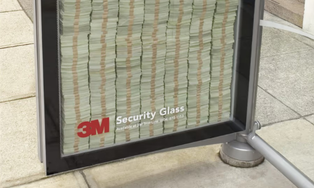 3M Scotchshield Security Glass bus shelter ad with stacked cash behind glass