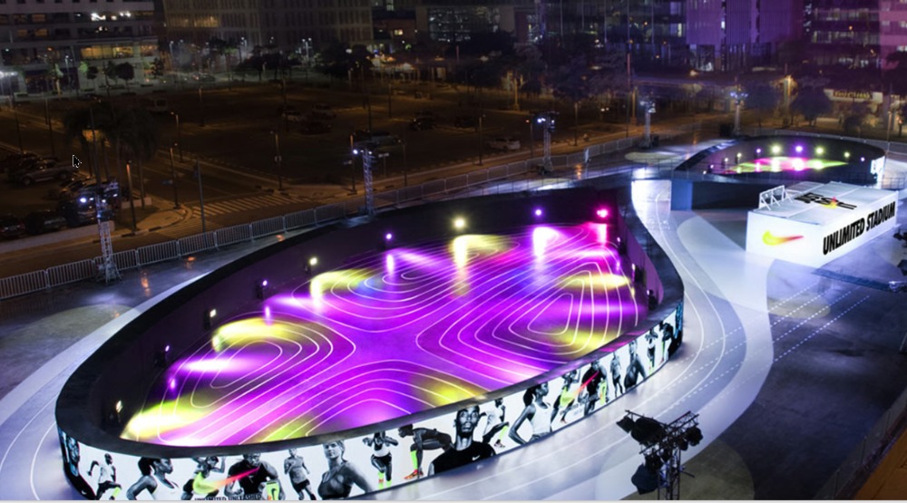 Nike Unlimited Stadium LED shoe-shaped running track lit up at night