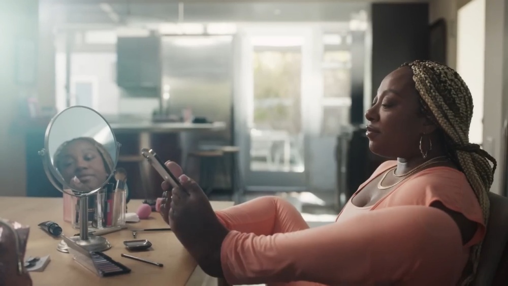 Woman holding her phone with her feet.