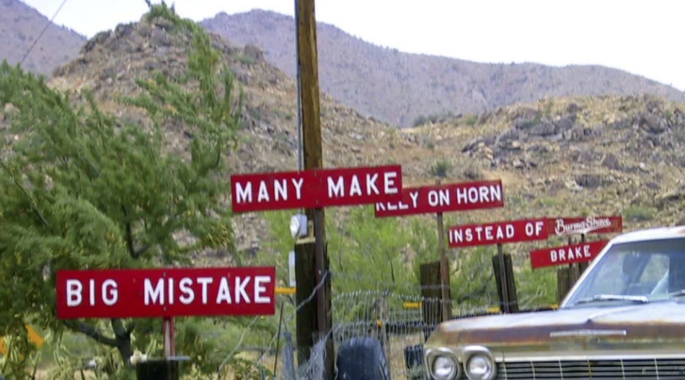 Parking lot with Burma Shave signs.