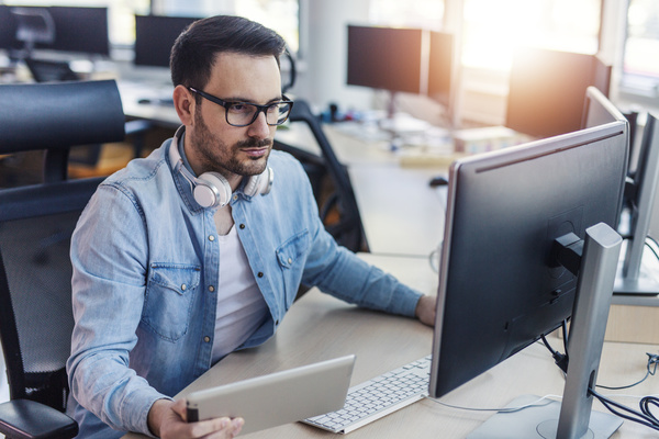 Data integration - Working at a desk with a computer.