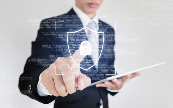 Man in a blue business suit pointing to a digitally created lock.
