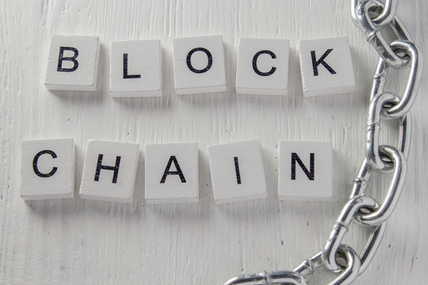 Blockchain word made from white blocks.