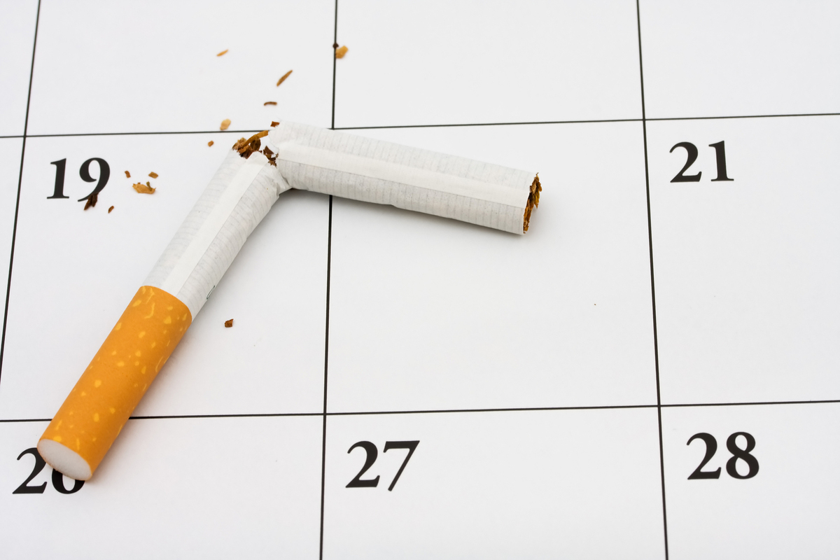 Calendar with a broken cigarette.