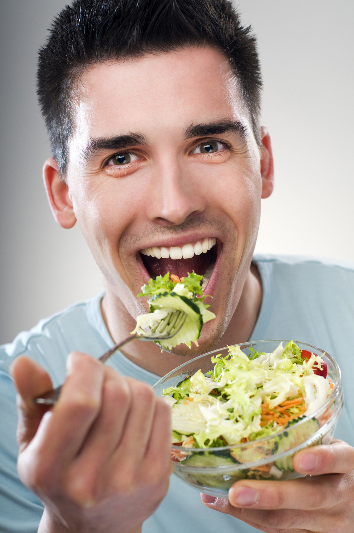 Man eating a salad.