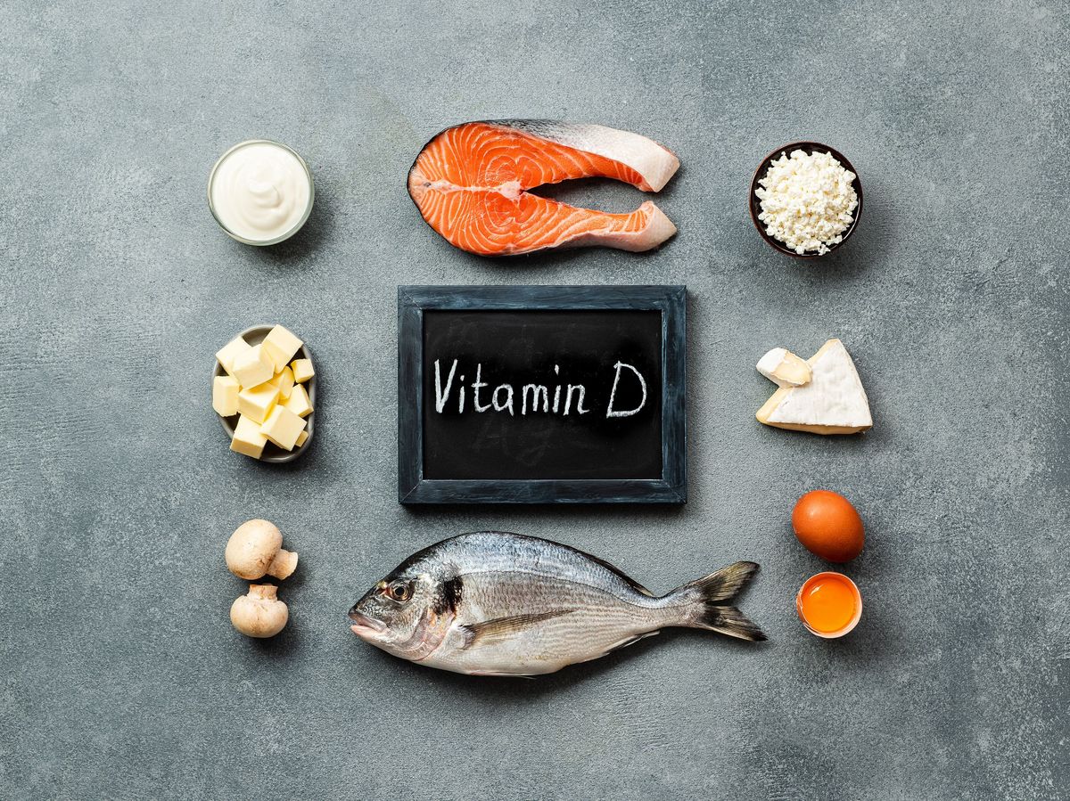 Chalk board labeled vitamin D with fish, mushrooms, cheese and cream.