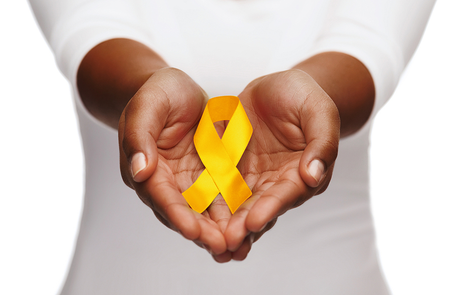 Holding a yellow ribbon in palms.