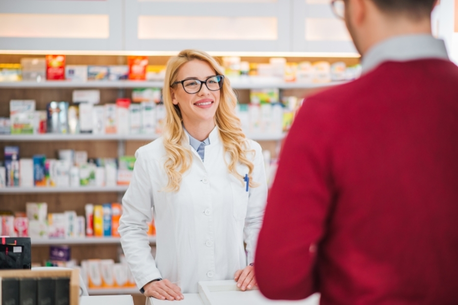 Pharmacist speaking with a customer.