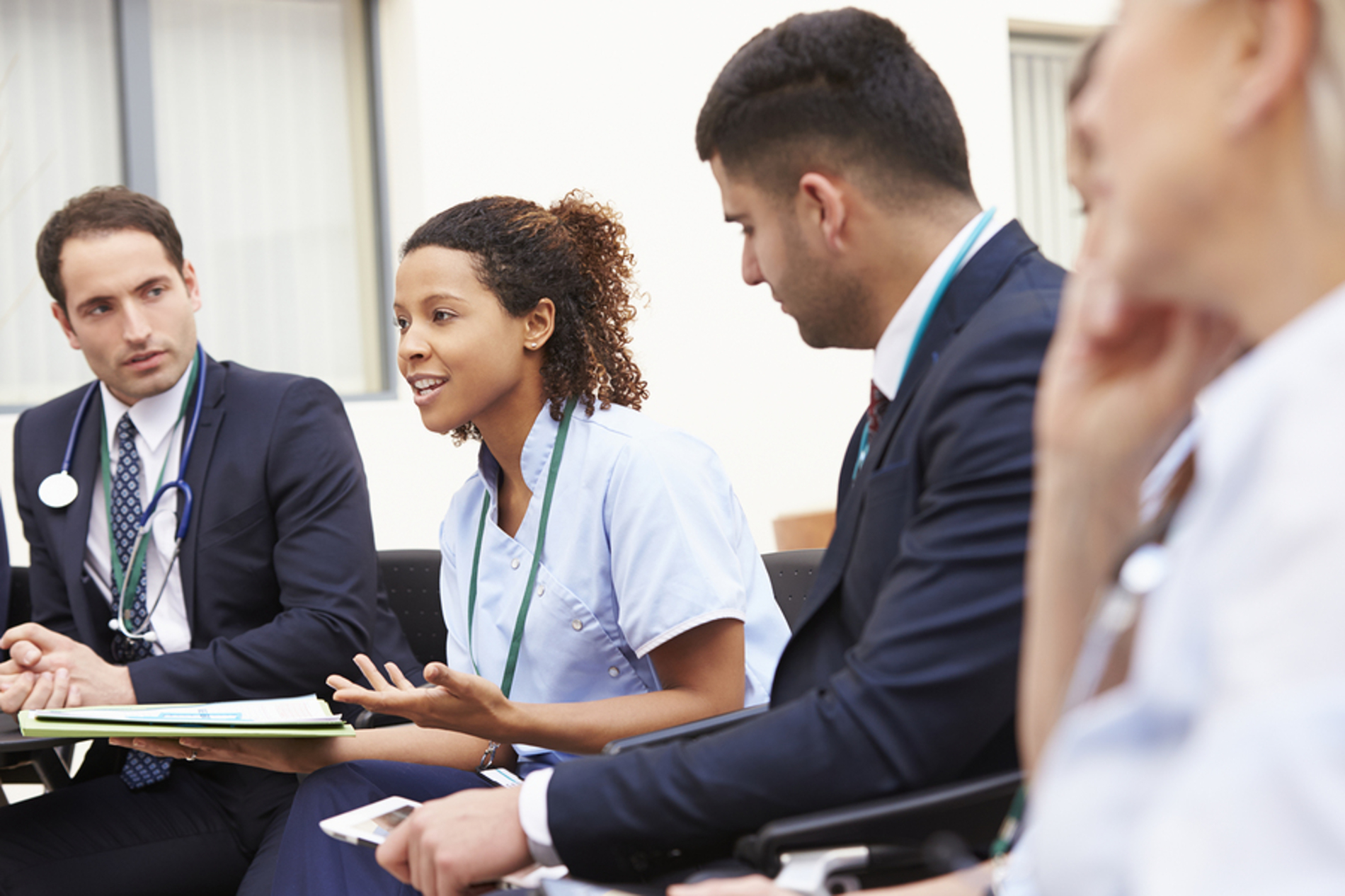 Group of medical doctors discussing patient care.