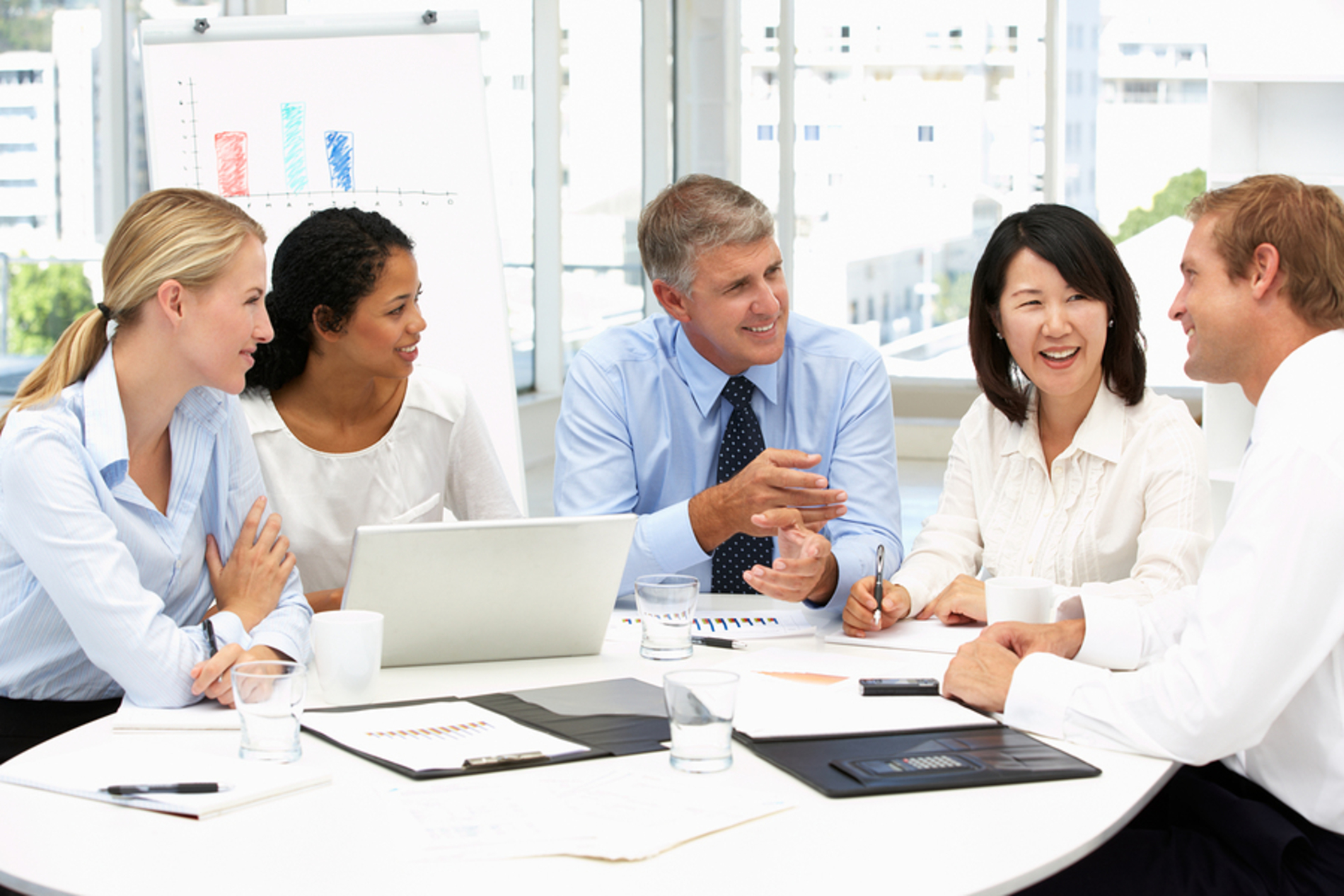 Group of colleagues sitting around a conference table.