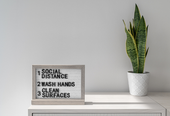 Social distance, wash hands and clean surfaces sign.