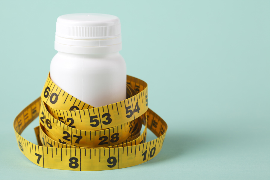Pill bottle and tape measure.