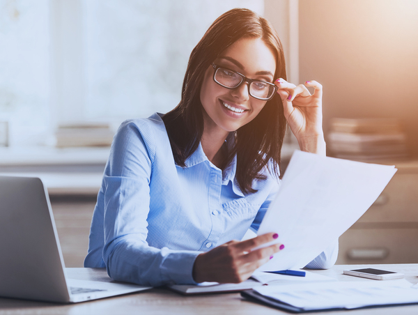 Woman wearing glasses reading a document.