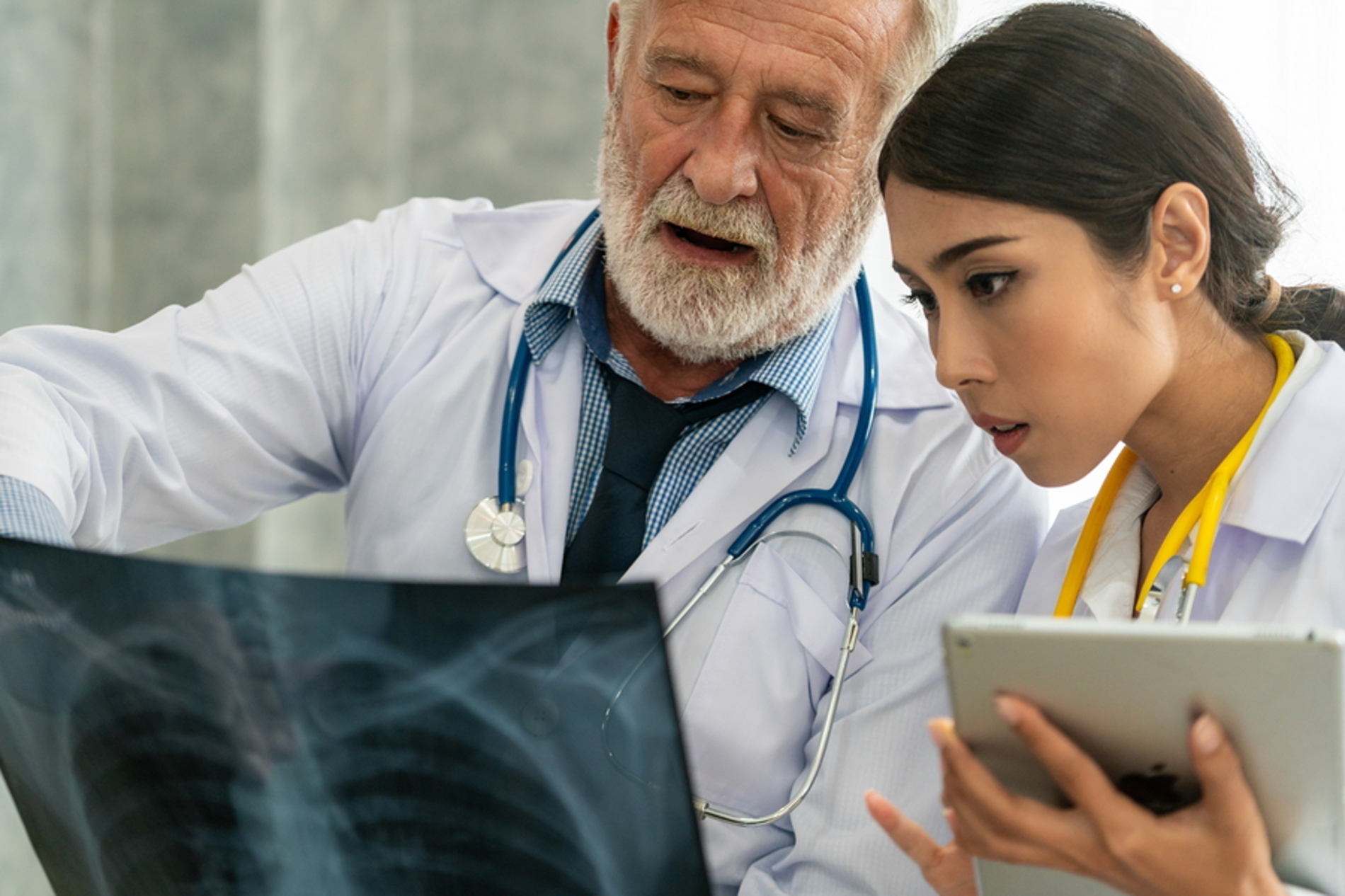 Two medical doctors reviewing x-rays.
