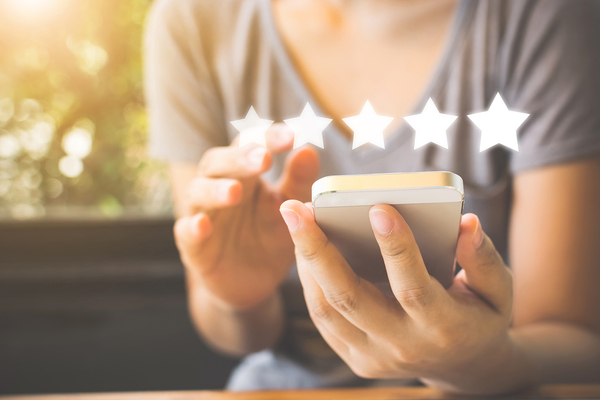 Leaving a five star rating on a phone.