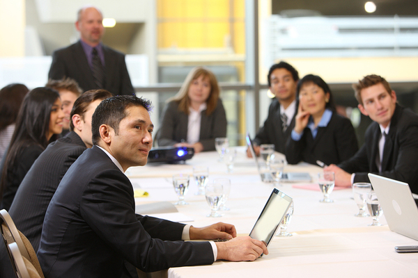 Group of co-workers working around a conference table.