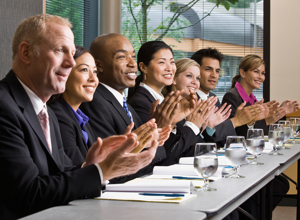 Group of co-workers clapping.