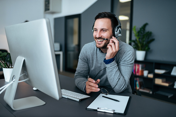 Wearing a headset at a desk. operational costs