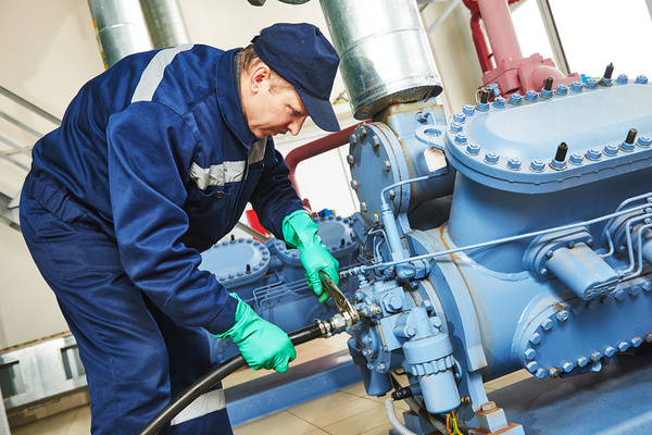 Worker repairing a piece of machinery.