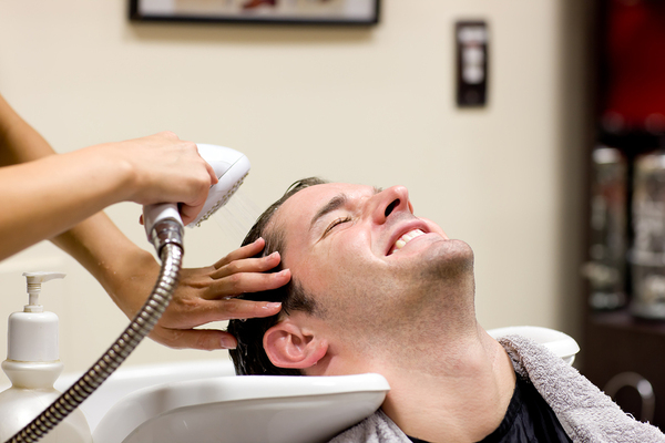 Man getting his hair washed at a beauty salon.