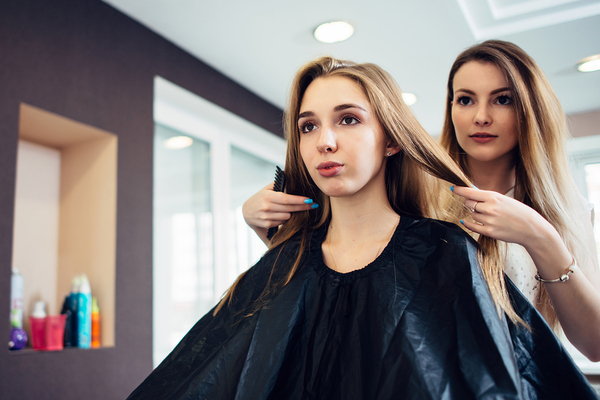 Woman at a hair salon getting her hair styled.