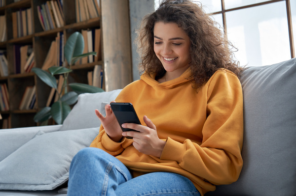 Digital Transformation - Smiling woman using her phone.