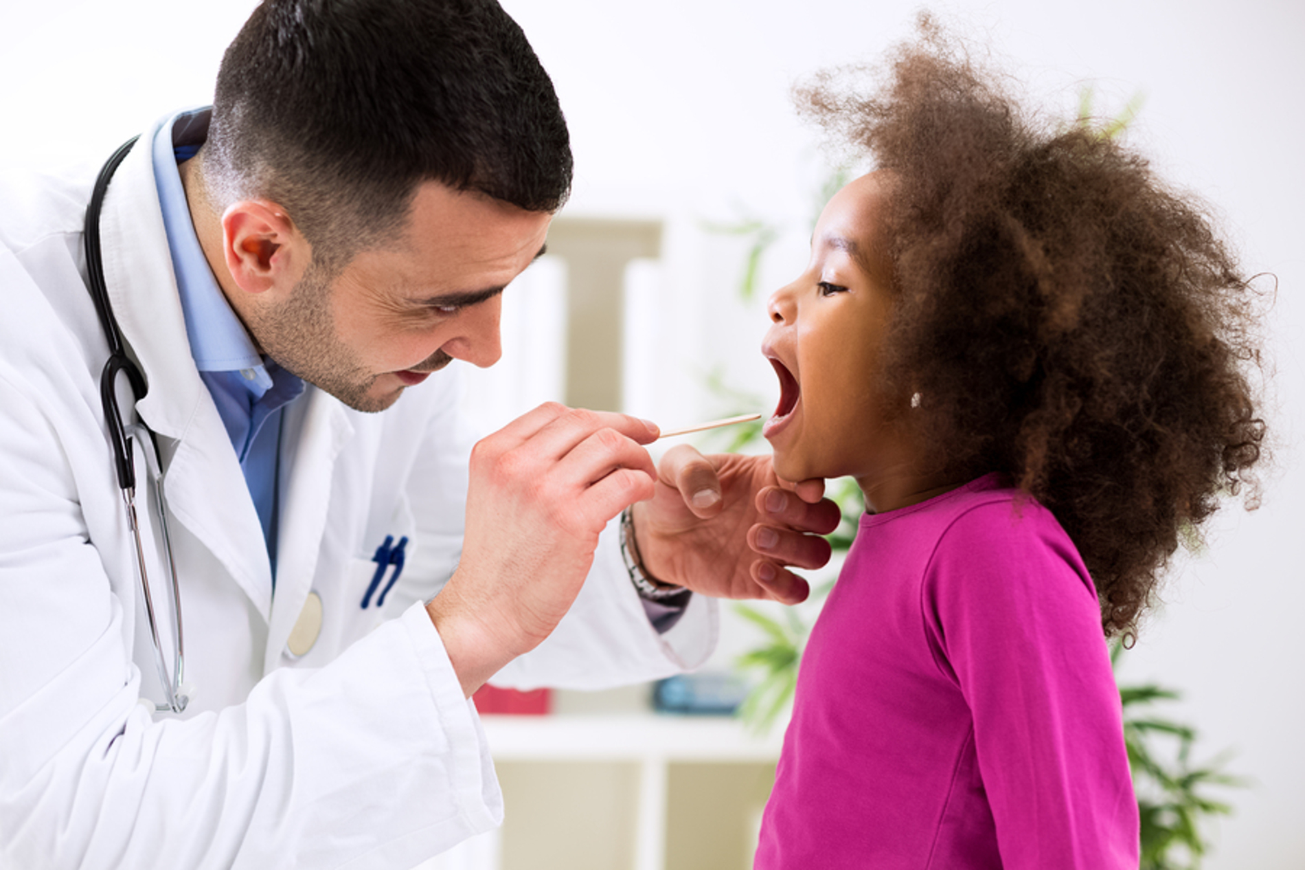 Medical doctor examining a young child. Medical doctor examining a young child.