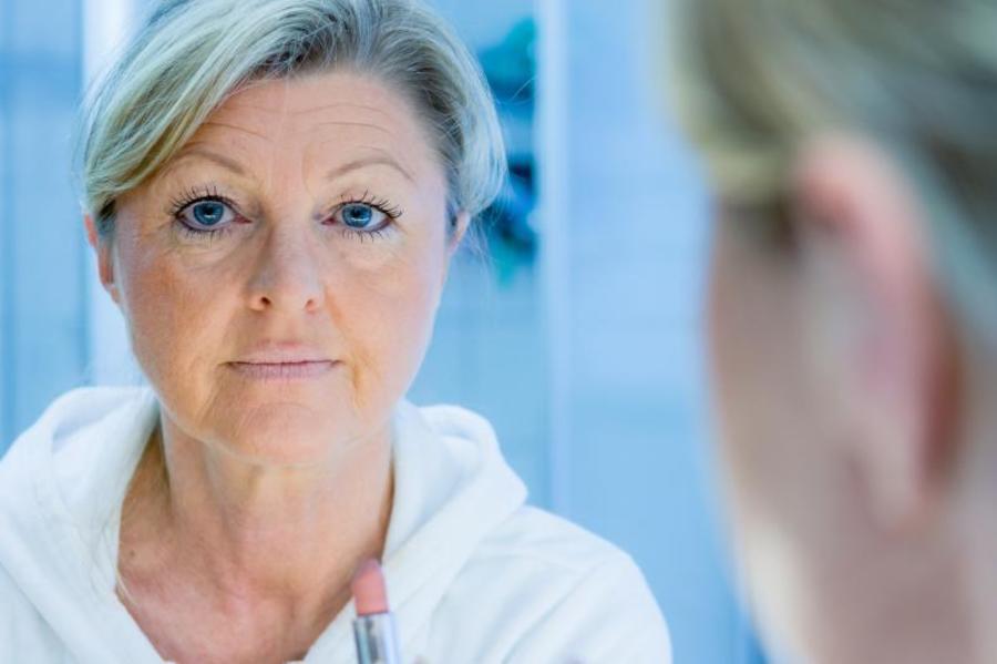 Woman looking in the mirror.