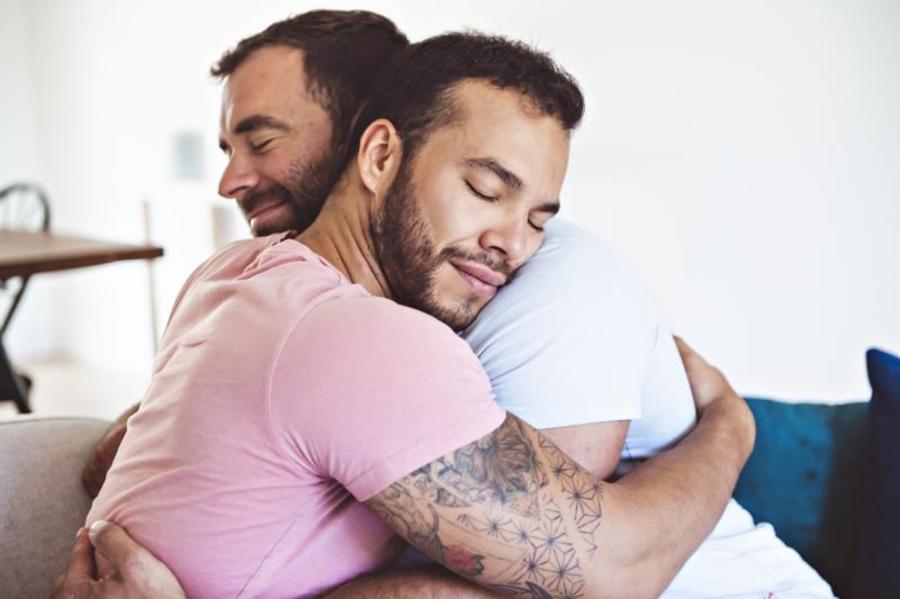 Two men hugging.