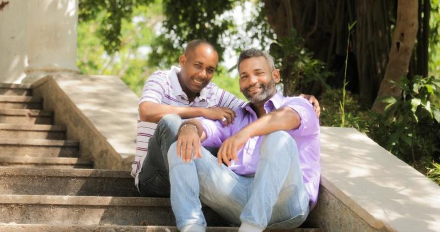 Two men sitting on the steps together.