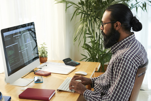 Blockchain developer working at his desk.