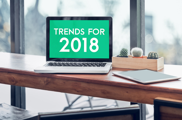 Desk with laptop computer displaying Trends for 2018.