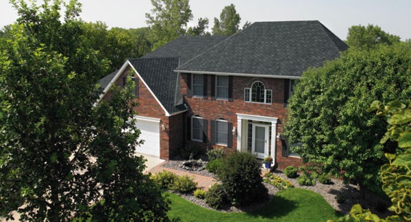 Single family home with two car garage and brick front.
