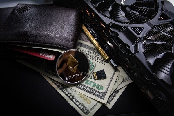 Wallet with paper money, computer fan and silver coin with ethereum symbol.