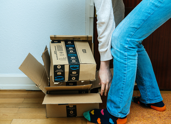 Person picking up empty cardboard boxes.