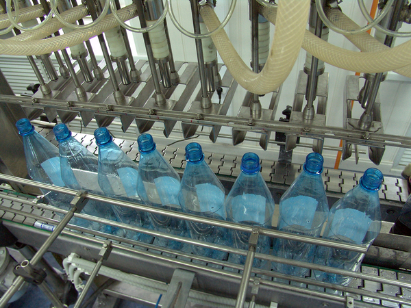 Factory machine filling bottles.