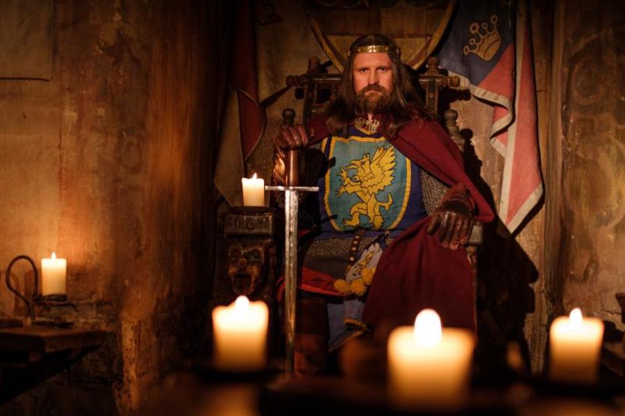King on a throne with sword.