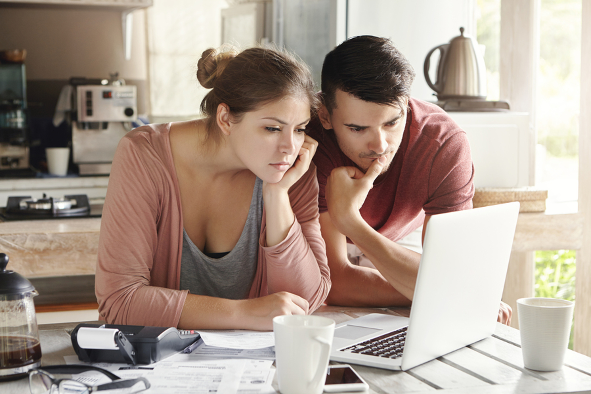 Young couple looking at a laptop together.