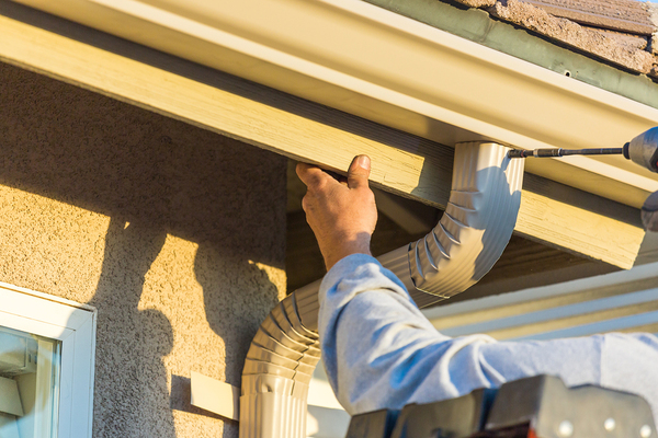 Person installing gutters.