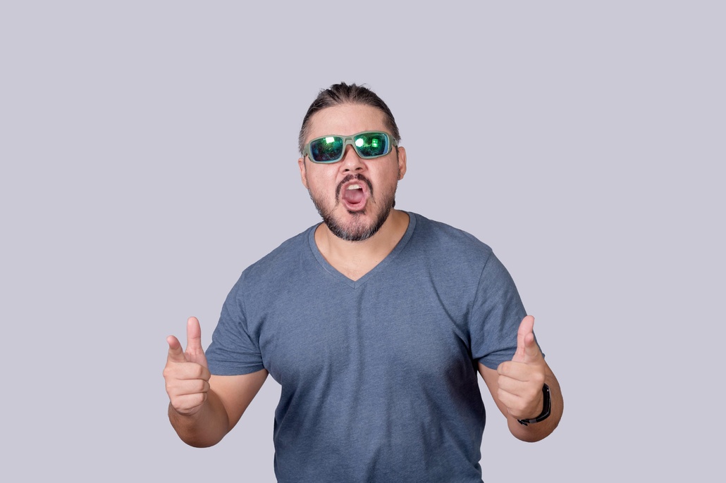 Man wearing sunglasses and yelling.