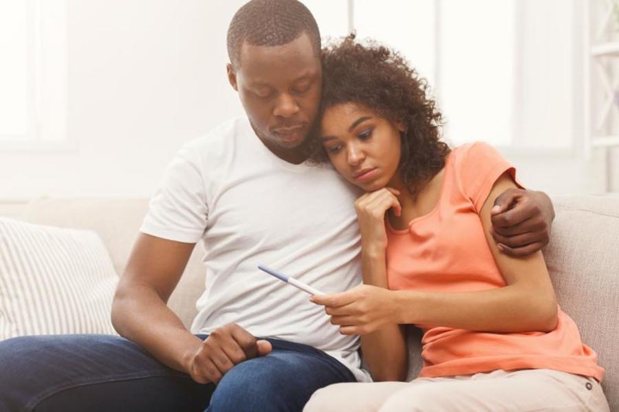 Couple looking at a pregnancy test together.