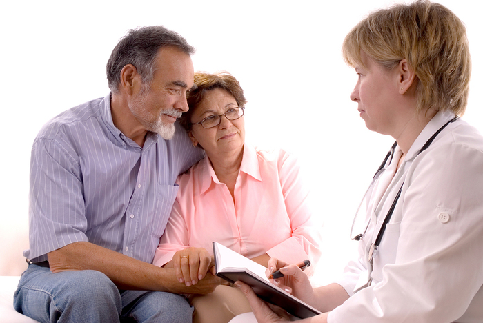 Older couple meeting with a doctor.