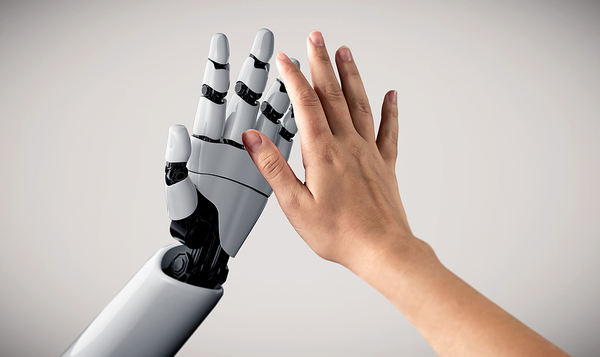 Human hand reaching out for a robotic hand.