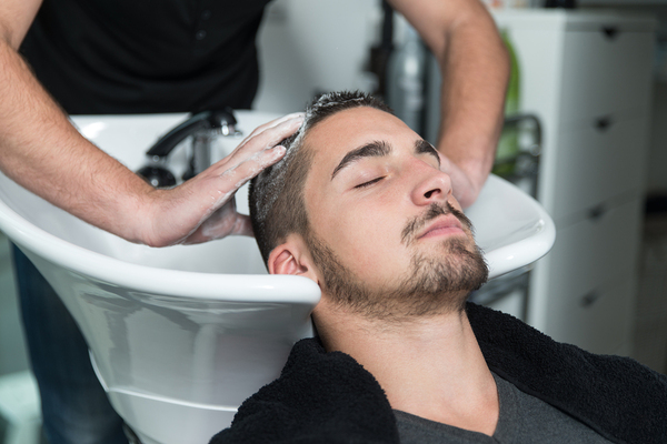 Man getting his hair washed in a salon.