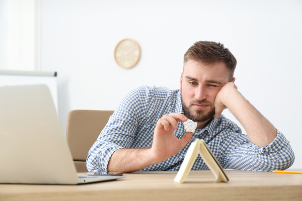Man taking a mental break at his desk.