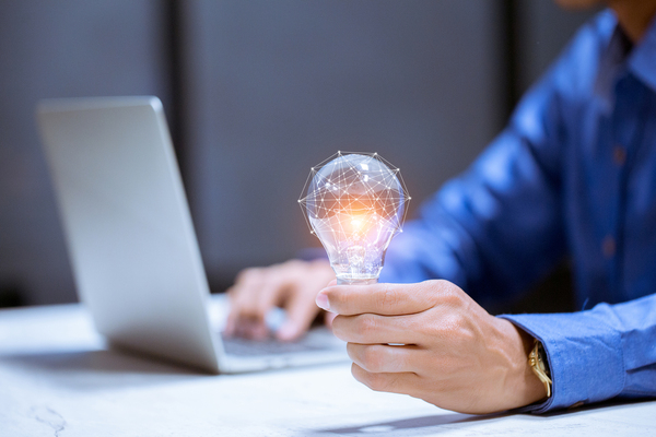 Holding a lightbulb.
