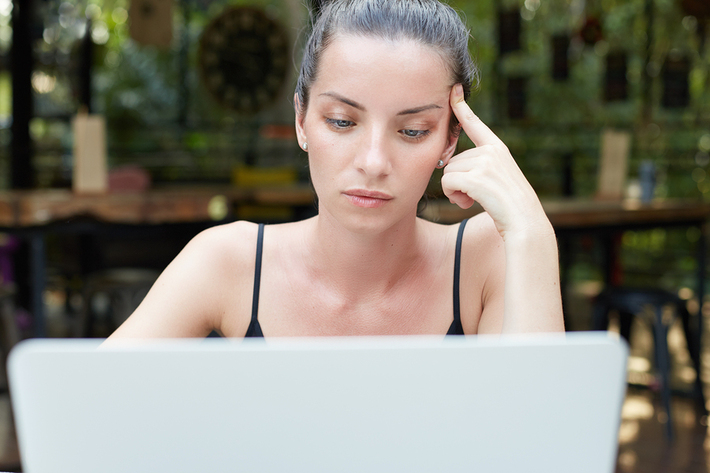 Woman looking at her laptop.